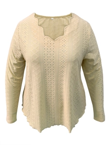 Detail of white long sleeve top featuring scallop V-neckline and eyelet embroidery pattern