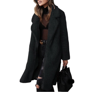 Detail of a black plush teddy coat with wide lapels and a warm wool-like fuzzy texture