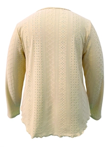 Macro detail of breathable hollow knit pattern on back of long sleeve scallop top