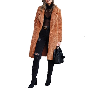 Close-up of caramel teddy faux fur coat texture with lapel collar for women