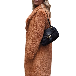 Side view of caramel teddy coat showing thick plush texture and wide lapel collar