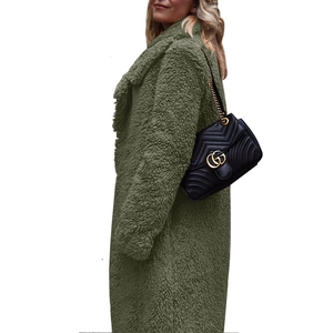 Detail of moss green teddy coat featuring a wide lapel and thick fleece texture
