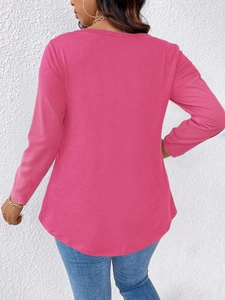 Back view of a vibrant magenta long sleeve top featuring an elegant curved hemline