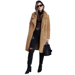 Full-body view of a long camel teddy coat with lapels and plush curly faux fur texture