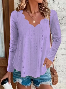 Detail of scalloped V-neckline and vertical eyelet embroidery on lavender long sleeve top