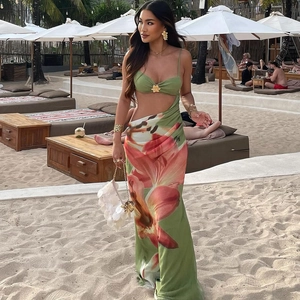 Detail of floral cut-out maxi dress featuring tropical prints and a stylish side cutout