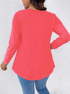 Back view of a casual coral red long-sleeve top with curved hem and soft knit texture