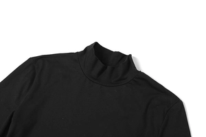 Detailed view of black mock neck stitching and mesh patchwork on a slim fit maxi dress