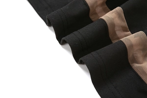 Macro shot of black fabric and mesh splicing with professional double-needle stitching detail
