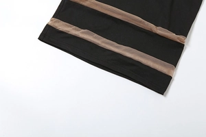 Detail view of black dress featuring brown mesh patchwork stripes for a layered texture look