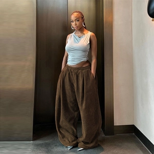 Detail of high waist corduroy wide-leg trousers and sleeveless top with side gathering