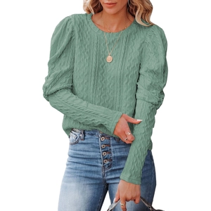 Sage green cable knit sweater with puff sleeves and crew neck styled with blue jeans