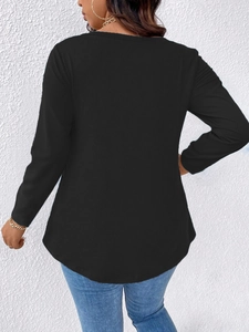 Rear view of plus size black long sleeve top showing the curved hem and relaxed fit