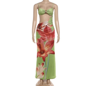 Detail of waist cut-out and red lily floral print on green slim fit maxi dress