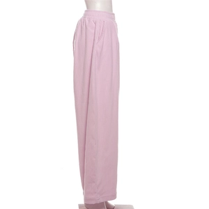 Detail of high waist corduroy trousers showing pink fabric texture and side pocket