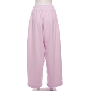 Detail view of pink corduroy casual pants with elastic high waist and ribbed texture on mannequin