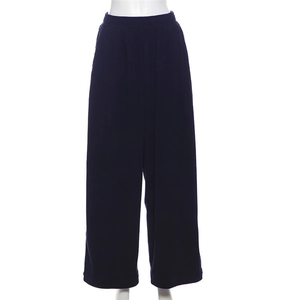 Detail view of high waisted navy blue wide leg pants with ribbed texture and elastic band