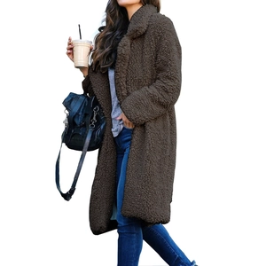 Close-up of plush dark brown teddy coat texture with classic lapel and long sleeves