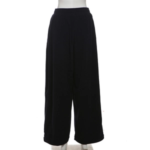 Detail of high waisted wide leg pants in navy blue with a vertical ribbed texture