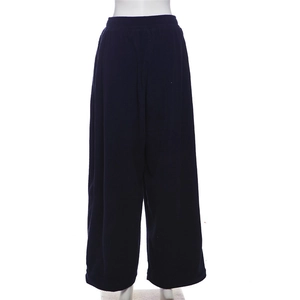 Detail of high waist wide leg navy corduroy trousers with elastic waistband texture