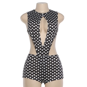 Detailed view of polka dot cutout bodysuit with deep V-neck and waist openings