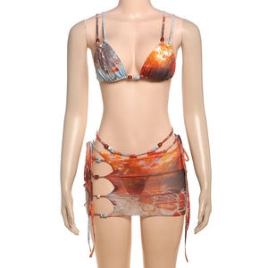 Detailed view of 3-piece printed bikini set with tie-skirt and bead accents