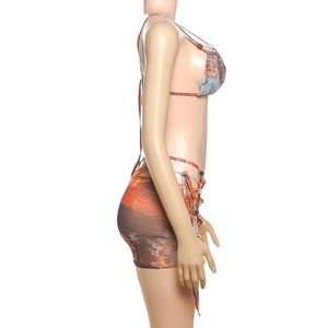Detail of three-piece printed bikini set with wrap skirt and abstract floral patterns