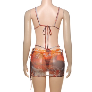 Rear view of women's three-piece bikini set with sheer mesh sarong in marble print