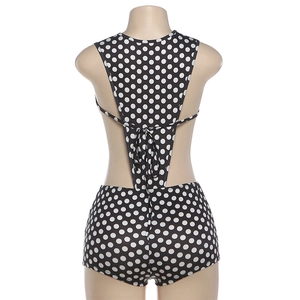 Detailed back view of the black and white polka dot swimsuit with cross-tie ribbons