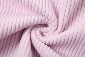 Macro close-up of soft pink corduroy fabric with vertical ribbed texture for women trousers