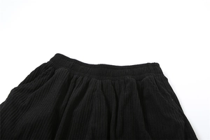 Detail of high waist elastic waistband on black corduroy straight-leg casual pants