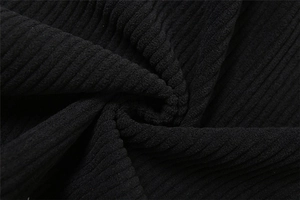 Close-up of black ribbed corduroy fabric showing thick texture and soft drape
