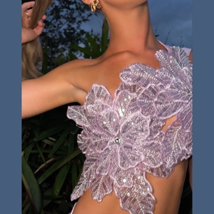 Detail of lavender sequin top with 3D floral embroidery and faux pearl embellishments