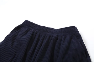 Close-up of navy blue corduroy pants featuring an elastic high waist and soft texture