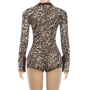 Macro detail of leopard print bodysuit featuring deep red ruffle trim and rear zip closure