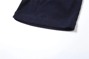 Detailed macro view of dark blue corduroy fabric with vertical ribs and hem stitching