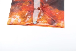 Close-up of abstract flame print mesh fabric featuring ethnic wood and marble beads detail