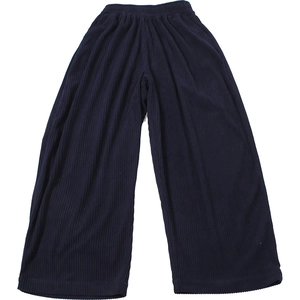 Detail of high waisted wide leg trousers showing vertical ribbed texture and elastic waist