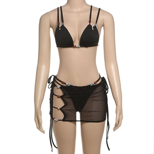 Detailed view of black three-piece bikini with colorful beads and mesh sarong cover-up