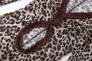 Detailed close-up of leopard print mesh bodysuit with brown ruffled edge and cut-out design