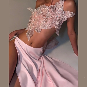 Detail of pink sequin floral crop top and high slit satin skirt evening set