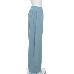 Detail view of high waisted light blue corduroy wide leg trousers with elastic waist and pockets