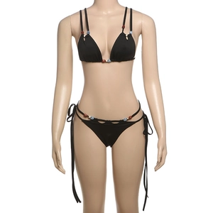 Detail of black bikini set featuring colorful beads on neck straps and side ties