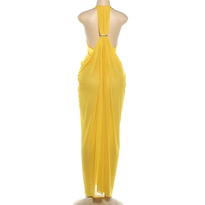 Detail view of bright yellow halter neck dress with mesh fabric and gold back buckle