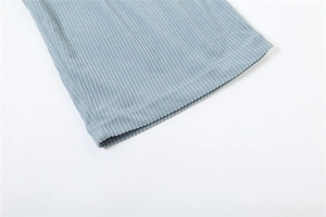 Close-up of light blue ribbed knit fabric showing detailed stitching and soft texture