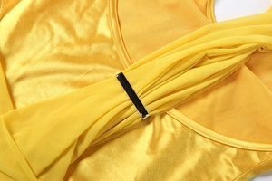 Detail of yellow satin fabric and mesh stitching with silver rectangular metal bar accent