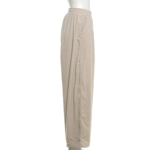 Detail view of beige corduroy wide leg pants featuring an elastic high waist design