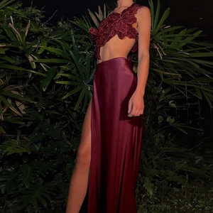 Close-up of wine red halter top with 3D floral embroidery and matching satin skirt