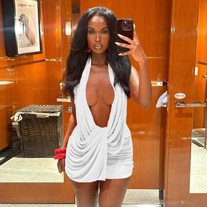 Detail of white deep V-neck halter mini dress featuring ruched sides and backless design
