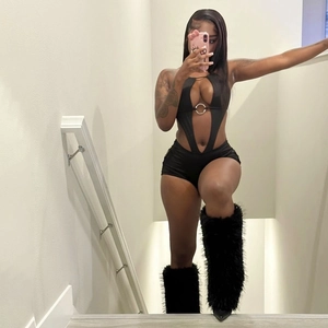 Sexy black cutout backless jumpsuit with metallic ring detail and faux fur leg warmers
